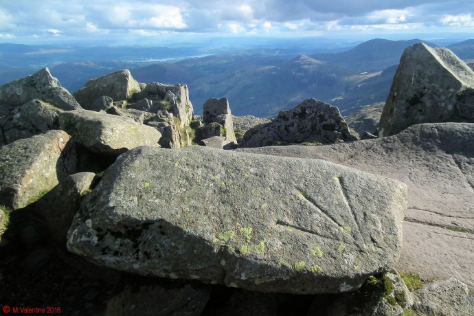 The bench mark "arrow" at Bowfell summit.