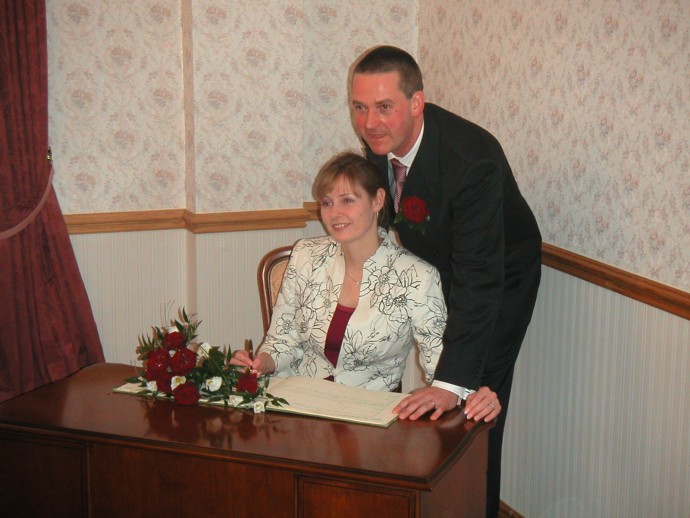 Chris and Sarah signing the book at the Register Office