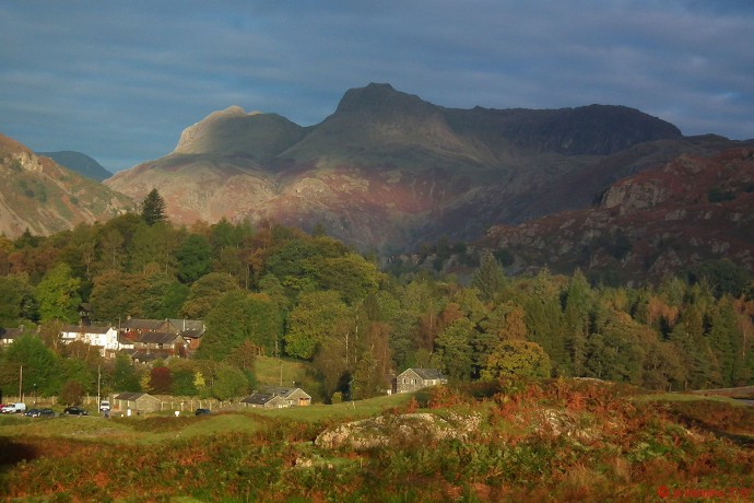 Autumn sunshine and dark skies over the Langdale Pikes.