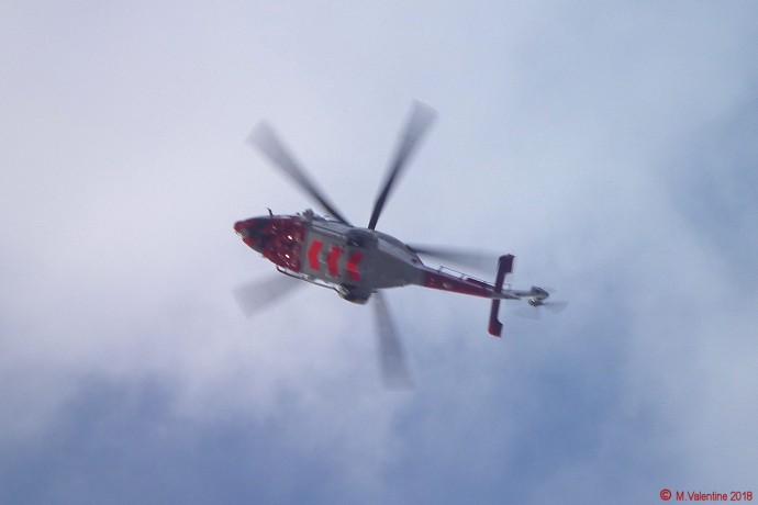 Coastguard helicopter leaving with casualty.