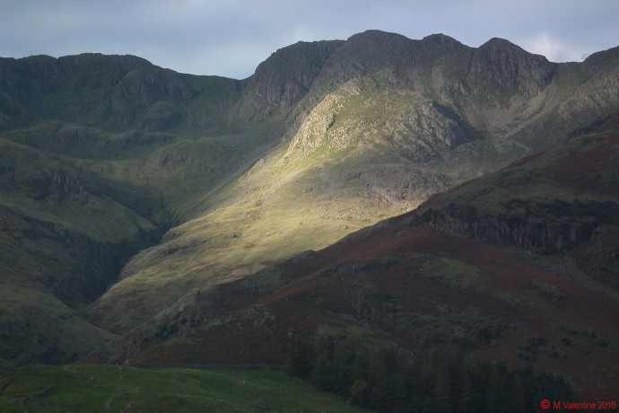 A shaft of morning sunshine hits Crinkle Crags.